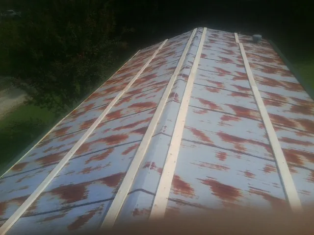 Rusted metal roof panels with new wood purlins before replacement — Storm Damage Roof Repair in Huger by Roofing Brothers